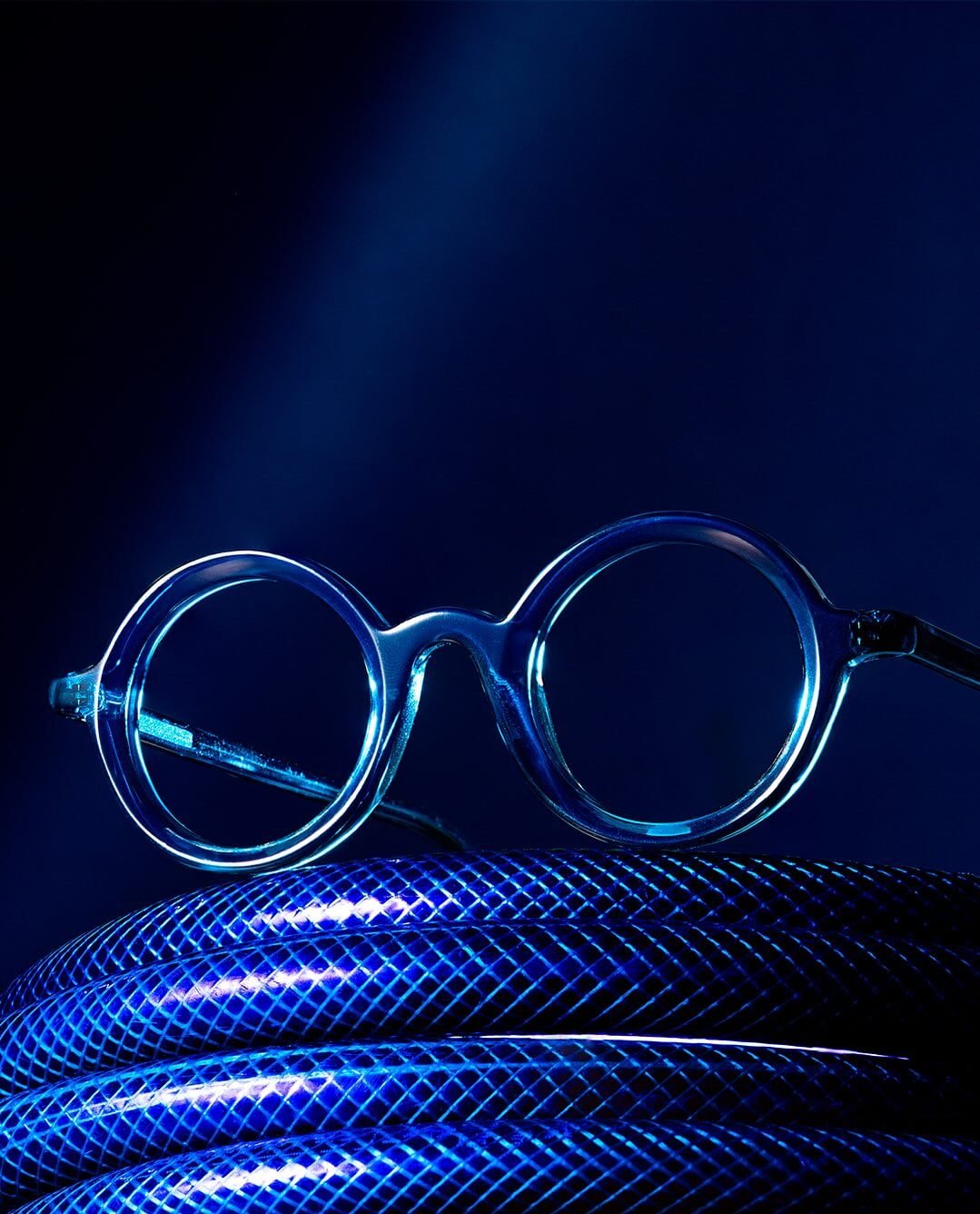 Close em armações de óculos coloridas organizadas em bandeja de exposição.